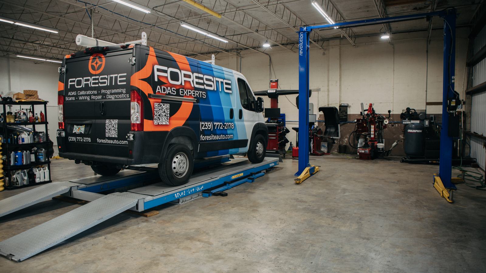 The mobile service van on the alignment rack inside the shop