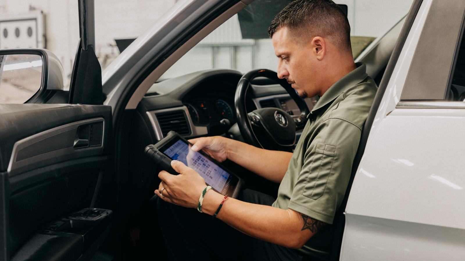 Technician scanning a vehicle from the driver's seat
